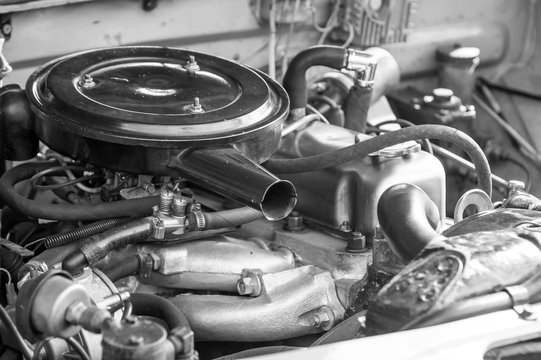 Under the hood cover of an old vintage car. Monochrome style photo.