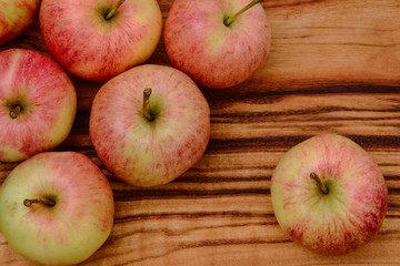 High angle view of a closeup of apples on a wooden board