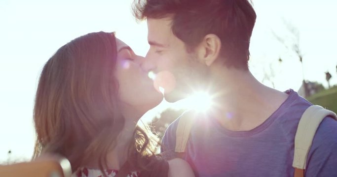 Tourist couple taking selfie photograph kissing Sacre Coeur Paris with smartphone in city enjoying summer holiday European vacation travel adventure 
