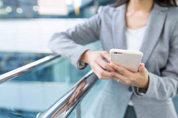 Businesswoman sending text message on mobile phone