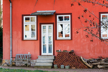 Fototapeta na wymiar A Red country house in Erfurt with white door on the terrace