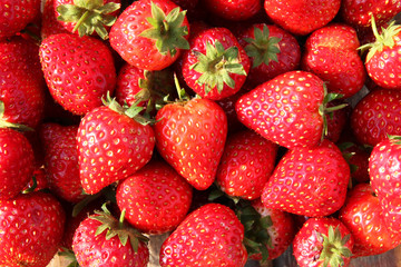 The ripe tasty strawberries on the market for background.