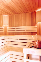Fototapeta na wymiar Sauna room. Wooden sauna interior with copper bucket. Bath accessories. Finnish sauna of small size.
