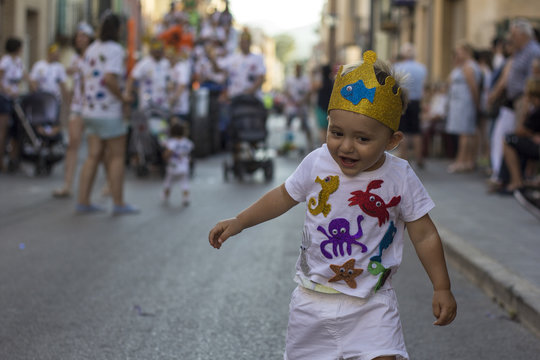 Baby dancing on the street during a costume party