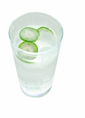 A refreshing glass of ice water flavored with cucumber slices isolated on white
