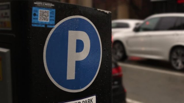 Digital electronic Parking machine in downtown area on rainy evening