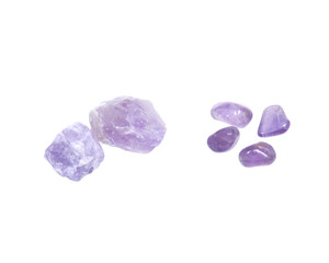 Amethyst: natural chunks from Madagascar and tumbled stones from Brazil isolated on white background