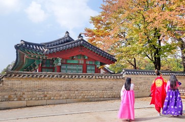 Tourists dressed in Hanbok, a traditional dress walking in Changdeokgung Palace in Seoul City, South Korea .