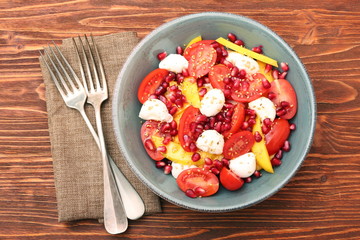 Tomato salad, mango and mozzarella with pomegranate seeds