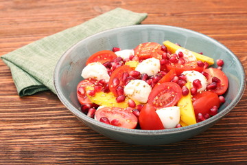 Tomato salad, mango and mozzarella with pomegranate seeds