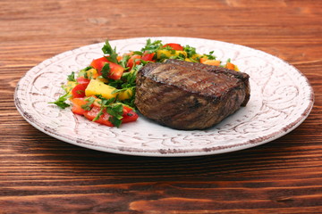 Grilled beefsteaks and vegetables