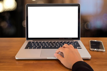 Fototapeta premium Young business women hand using laptop computer and smartphone in home office with blank screen and bokeh background.