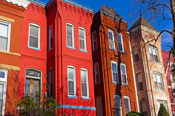 Historic urban architecture of Vernon Square neighborhood in Washington DC. Colorful residential row houses under bright afternoon sun.