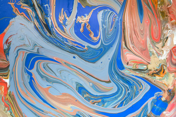 A colorful background of different colours of paint swirled together making a marbled effect