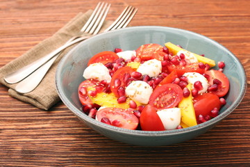 Tomato salad, mango and mozzarella with pomegranate seeds
