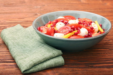 Tomato salad, mango and mozzarella with pomegranate seeds