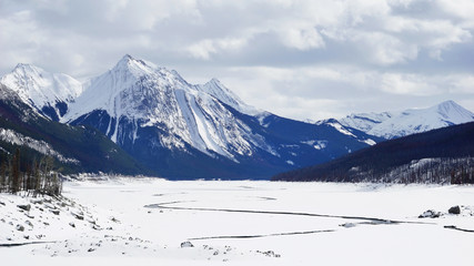 frozen lake and mountains covered with snow in National Park