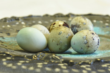 Beautiful image of quail eggs on an ornate antique silver plate