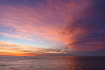 Naklejka na ściany i meble Beautiful sunrise, sunset sky over calm ocean