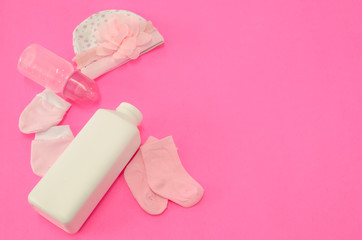 Generic baby girl items on hot pink background with lots of copy space