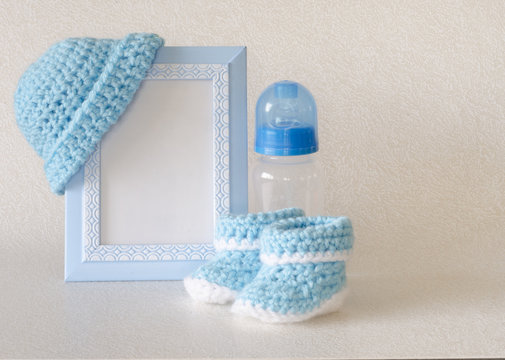 Blue baby items with copy space in frame for birth announcement