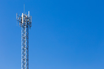 telecommunication cellular tower against cloudy blue sky