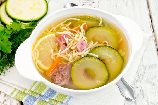 Soup with zucchini and noodles on napkin