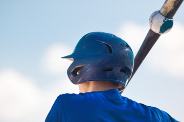 Baseball player holding baseball bat.