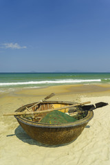 Fototapeta na wymiar Bamboo waterproof round fishing boat at the China Beach in Vietnam.