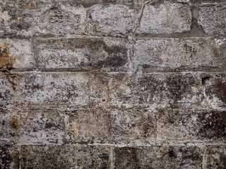 Old brick wall texture painted white deteriorate in the sunlight