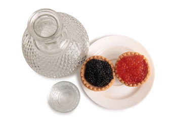 Fish caviar and glass of vodka on white background