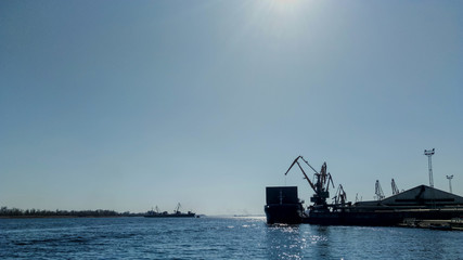 Container Cargo ship with working crane in port