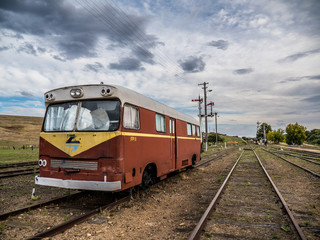Old train carriage bus restoration parked on train tracks