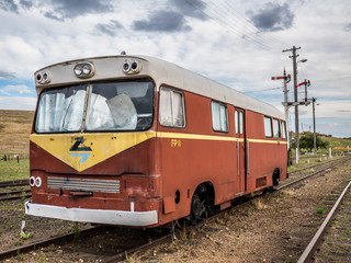 Old train carriage bus restoration parked on train tracks
