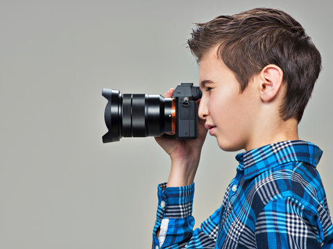 Boy with photo camera taking pictures.