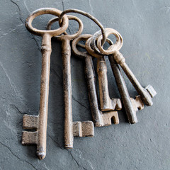 Large distressed looking iron skeleton keys on a ring.