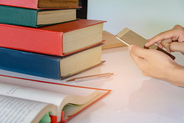 Man is playing mobile on the desk work