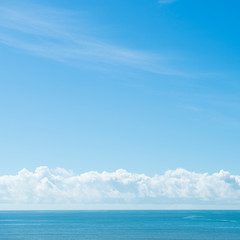 Naklejka na ściany i meble Blue sea with white clouds for background.