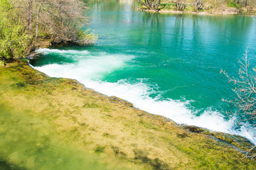 Naklejka na ściany i meble Waterfall and clear green water on Mreznica river in Croatia. Panoramic view. 