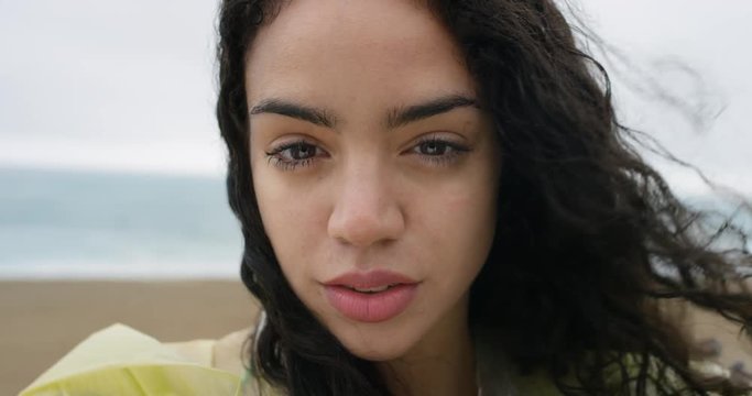 Close up portrait of beautiful african american teenage girl serious and sensual wet hair blowing in wind in rainy weather slow motion