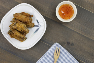 Buffalo chicken wings fried with sauce on wooden table