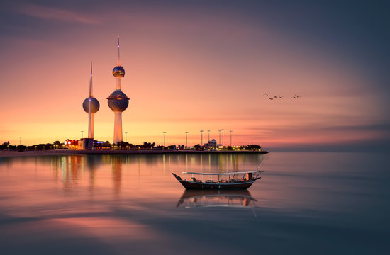beautiful arabian boat in in front of kuwait tower during sunset