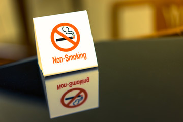 The warning signs banning smoke on the table.