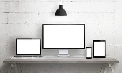 Responsive web site mockup. Computer display, laptop, tablet and smart phone on desk with isolated,...