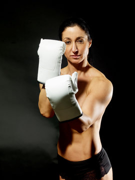 Muscular boxing woman showing her muscles.