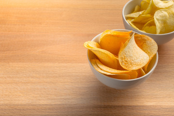 Pretzels in bowls on wooden table from above