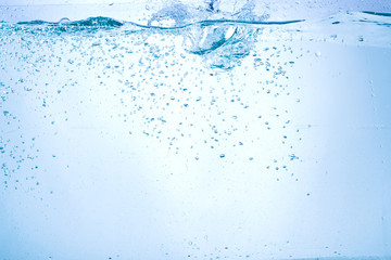 Flowing water, drops, sprays, splashes on a neutral background