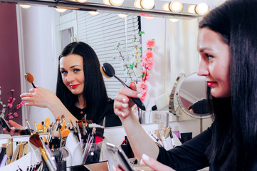 Makeup artist working with makeup table and mirror