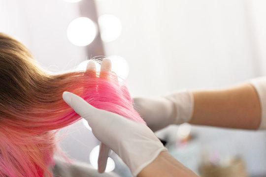 Hairdresser does hair style of woman