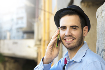 young man talking on the phone in the city